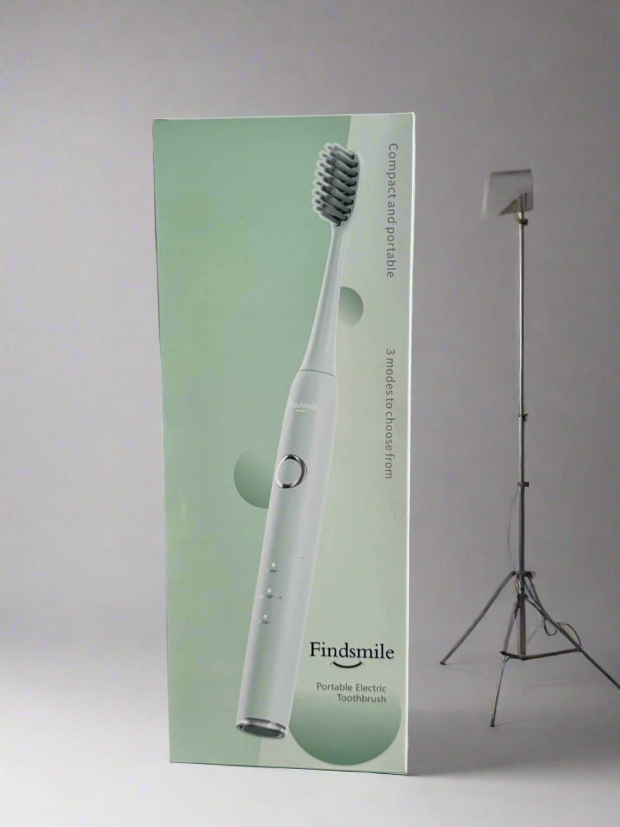 Findsmile portable electric toothbrush packaging on a textured surface